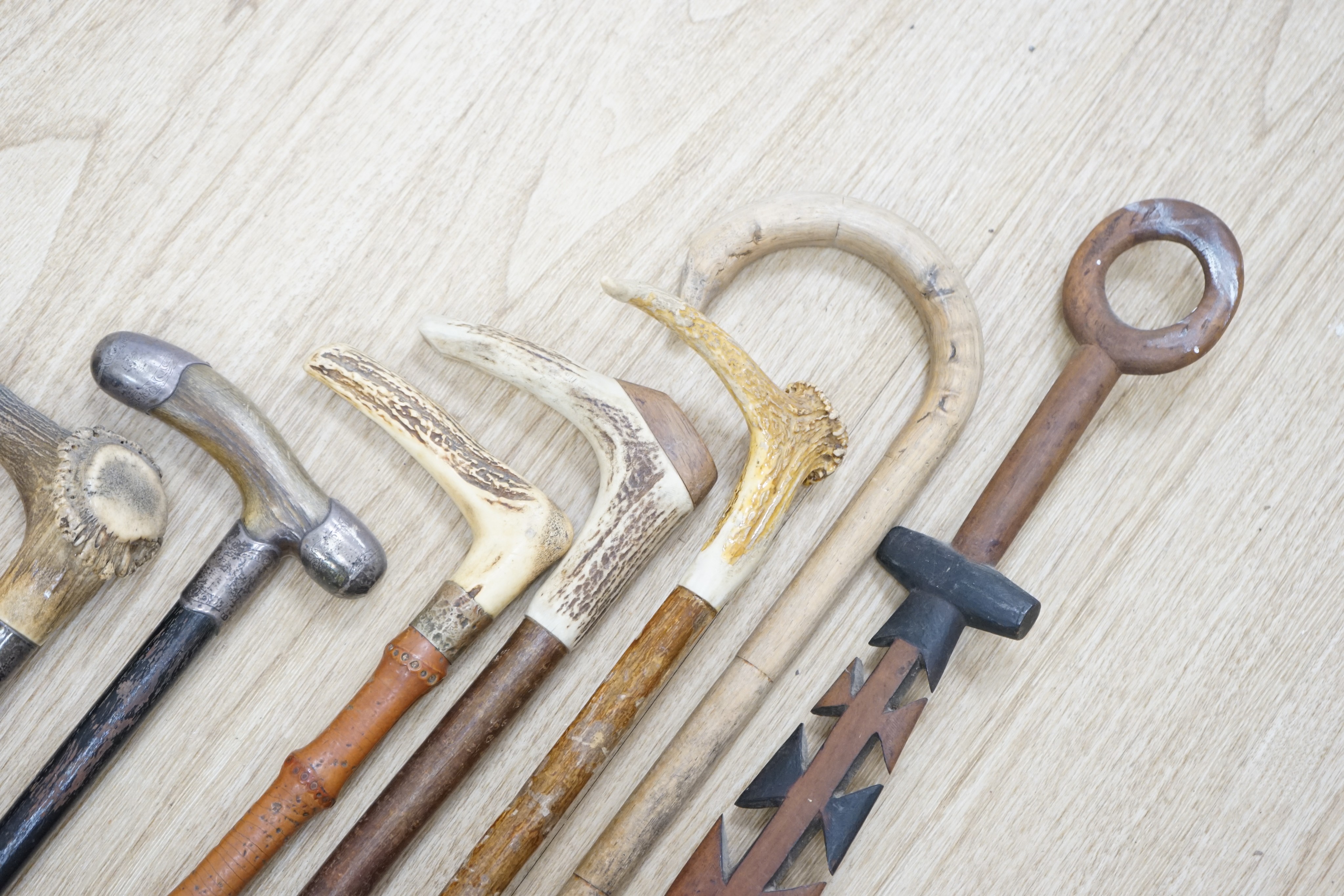 Twelve assorted walking sticks including silver mounted and staghorn handled